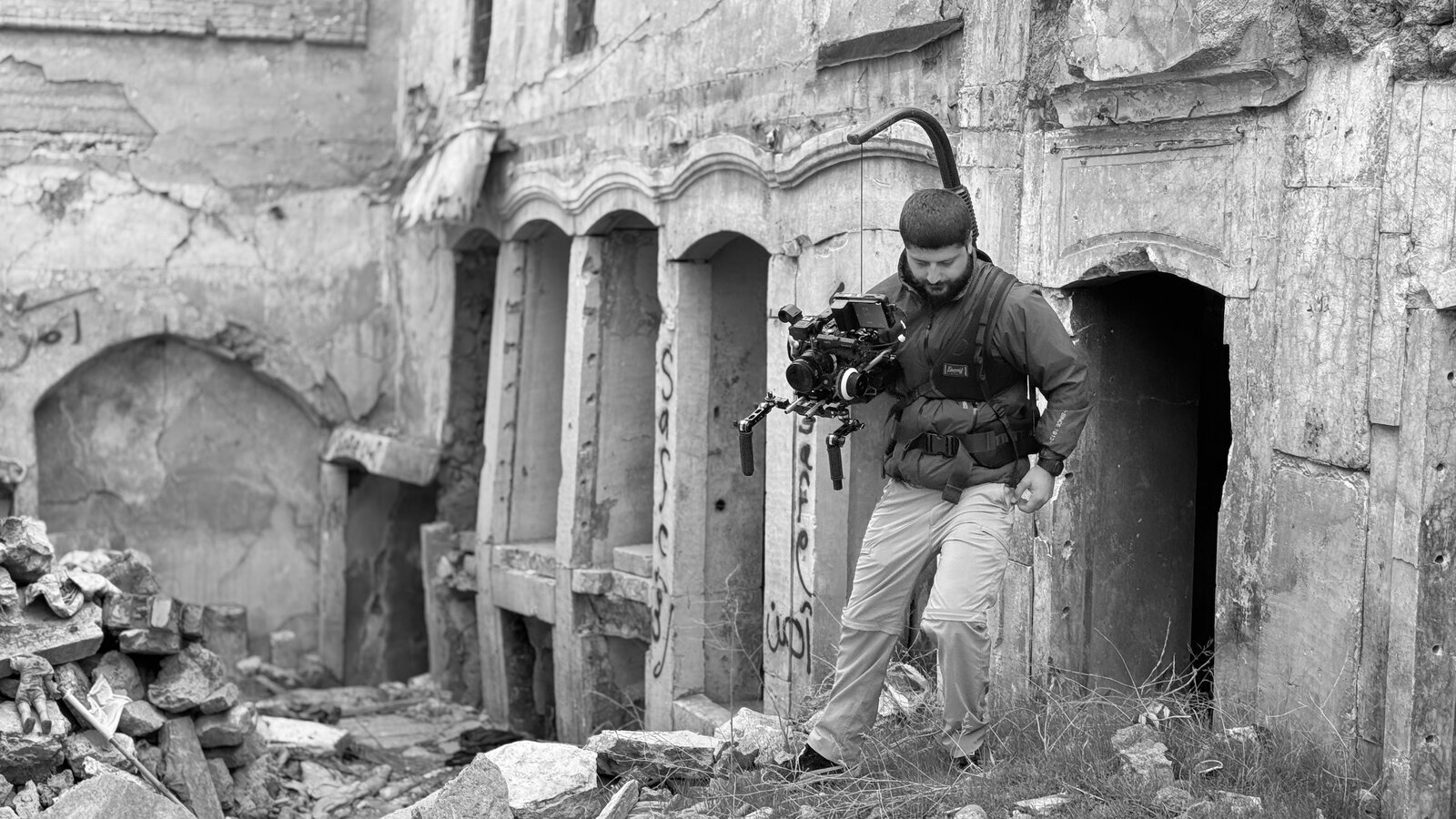 Ayar Rasool operating a camera rig in the ruins of Mosul