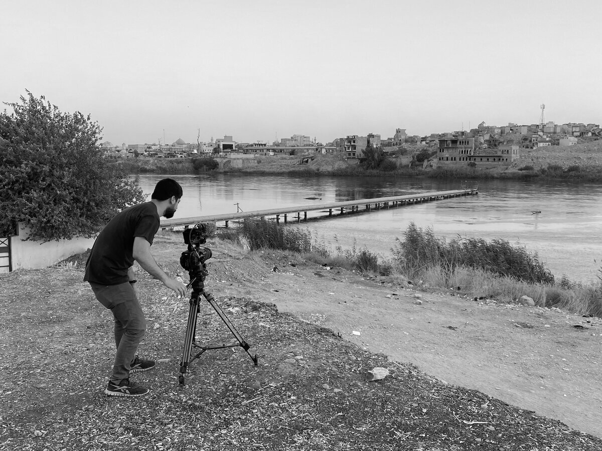 Editorial portrait of Ayar Rasool with camera equipment
