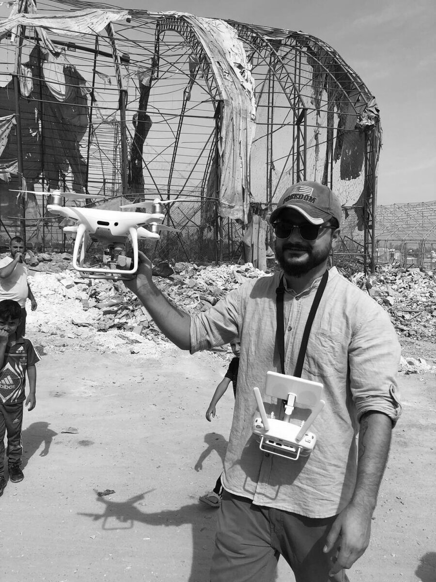 Ayar Rasool launching a drone amid the ruins of Mosul