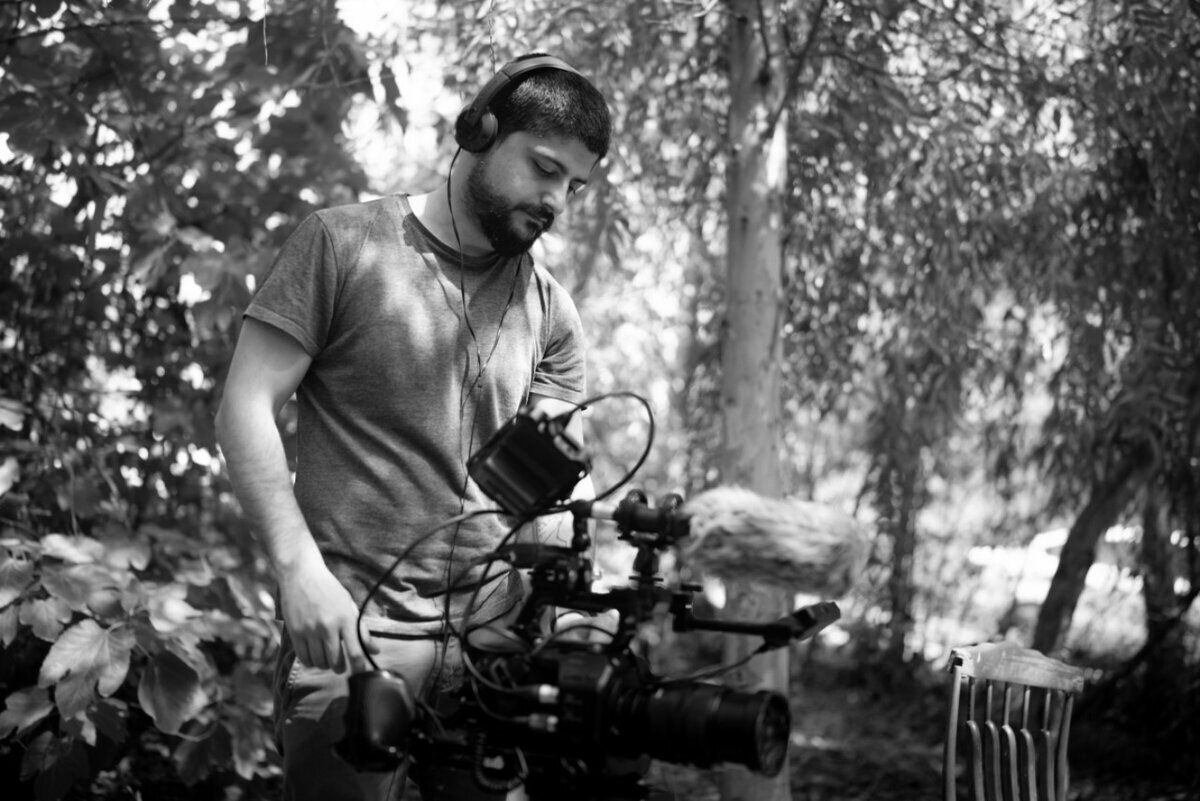Ayar Rasool operating a gimbal camera rig in a forest
