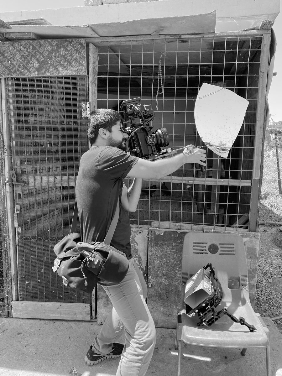 Crew member using a reflector during a shoot
